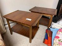 Front view showing both tables side by side on carpet against paneled wall