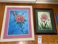 Both framed floral paintings seen side by side, showing size difference and frame styles