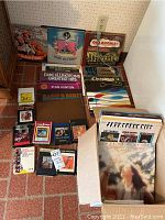 Photo showing multiple vinyl records standing upright including 'The Student Prince', Duke Ellington, Stan Kenton among others with several 8-track tapes in front.