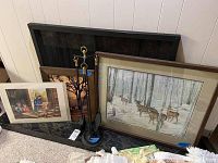 Signed and numbered print framed under glass, framed horse photograph, signed print in plastic sleeve, and fireplace tools with stand arranged on floor against wall.
