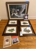 Photograph of the five framed wildlife prints arranged on a floor showing four smaller Don Balke prints with burlap matting and one larger Remington owl print.
