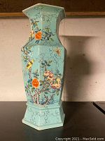 Front quarter view of hexagonal vase showing overall shape and floral and bird decoration