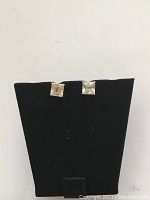 Front view of two square-cut clear stones set in 14K yellow gold prong settings on black earring display.