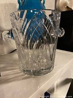 Front quarter view of crystal bucket showing overall shape, cut pattern, and handles