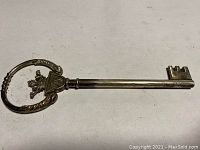 Full-length view of silver presentation key showing handle and blade