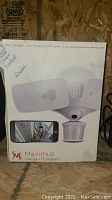 Box of Maximus Camera Floodlight showing branding and key features on front panel