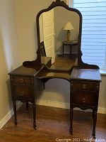 Full view of vanity showing mirror, drawers, legs