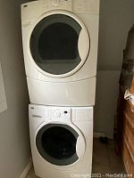 Stacked washer (bottom) and dryer (top) in white finish