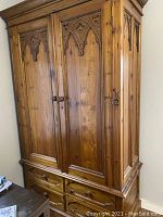 Front view of the Mexican styled solid wood bedroom wardrobe showing carved double doors and four drawers beneath.