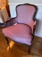 Front angle view of Ethan Allen upholstered chair showing carved wooden frame, cushioned purple upholstery with subtle dotted pattern, and seat shape.