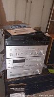 Stack of four Yamaha components showing amplifier, tuner, cassette deck and CD player