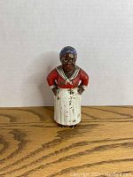 Front view of Mamie In The Kitchen cast iron bank showing detailed paint and figurine stance