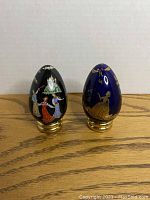 Both Franklin Mint Easter egg collectibles on table with white background.