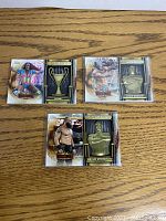 Front of three WWE 2020 Battle Royal cards featuring wrestlers Kofi Kingston, Montez Ford, and Braun Strowman alongside trophy images.