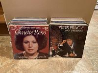 Photo showing two stacks of vinyl records featuring album covers by Ginette Reno and Peter Pringle at front.