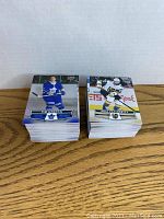 Two large stacks of 2021/22 Tim Hortons hockey cards featuring players Auston Matthews and Marc-Andre Fleury