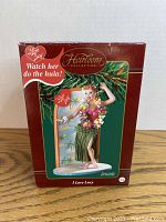 Photo of the original box of the ornament showing branding and theme