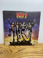 Front cover of Kiss Destroyer vinyl album showing band members in costume, colorful artwork.