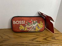 Closed front view of Nintendo Switch carrying case showcasing the Bowser graphic and 'BOSS!' text.