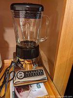Front view of the Cuisinart blender with glass pitcher, showing the control panel and power cord.