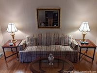 Living room view showing both tables flanking sofa
