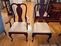 Front view of armchair and side chair showing cherry wood frames and upholstered seats