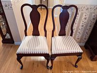 Front view of both chairs showing overall design, finish and upholstery