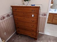 Front view of solid oak six-drawer tall dresser