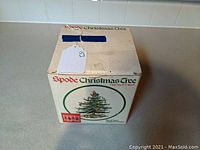 Box of Spode Christmas Tree highball glasses with store tag on top