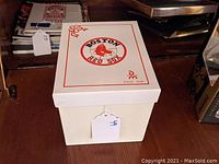 Closed white box with Boston Red Sox logo and red trim on lid.