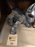 Blue robotic dog toy with visible joints and ears in close view