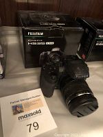 Digital Fujifilm FinePix HS35EXR camera shown with original box. Camera features 30x zoom lens and textured hand grip. Seller states untested.