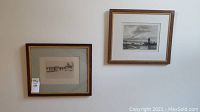 Two framed etching prints hung side by side on a wall