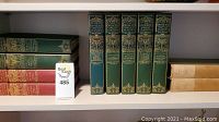 Photo of six volumes from The World's Greatest Classics book series, green hardcovers with gold spine detailing and titles, plus a red spine book.