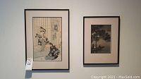 Photo showing two framed art pieces hung on wall: left Japanese print of woman seated, right landscape print.