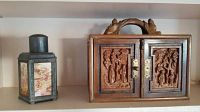 Front view of wood box (right) and metal tea caddy (left) side by side on shelf