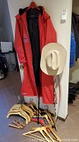 Full lot overview with raincoat, hat, walking sticks, hangers