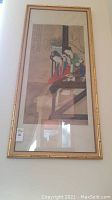Full front view of framed silk painting hanging on wall