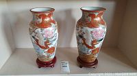 Two matching vases side by side on stands