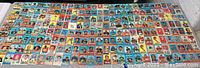 Wide view of a large collection of football cards laid flat showing multiple rows of cards from different teams and players.