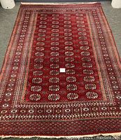 Full view of the rectangular red rug on floor