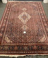 Full view of rectangular rug showing central medallion and border
