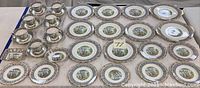 Full set layout with multiple cups, saucers, salad plates, and serving dishes showing the full extent of the set.