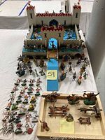Full overview of castle playset with scattered figures in front
