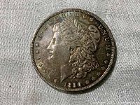 Obverse side of 1890 Morgan dollar showing Lady Liberty and date with toning present.