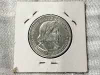 Obverse side of the coin showing Christopher Columbus profile and inscriptions.