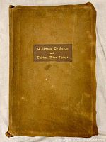 Front suede cover of antique book 'A Message To Garcia and Thirteen Other Things' showing the book title on a dark patch with gold embossed text. Shows flap-over cover edges and wear consistent with age.