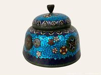 Front view of antique cloisonné lidded trinket box showing vibrant blue enamel with floral patterns and black finial handle on lid.