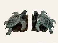Front view of both bookends on neutral background showing turtles facing camera