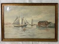 Full front view of framed harbor watercolor with sailboats, dockside buildings and rowboat